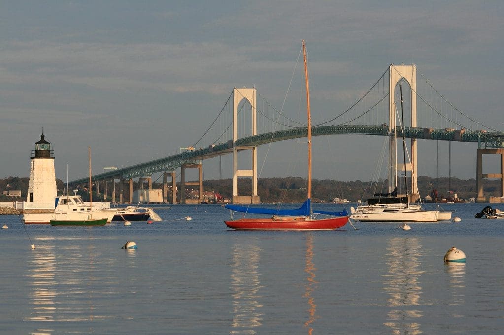 Sailing boats near lighthouse and bridge