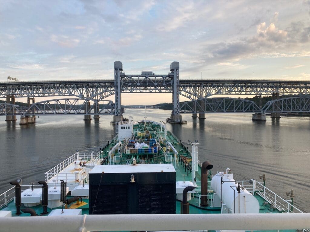 Ship passing under bridge