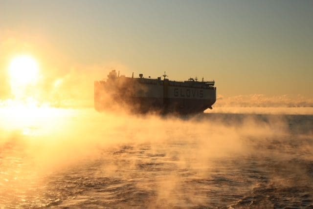 Ship in foggy sunrise