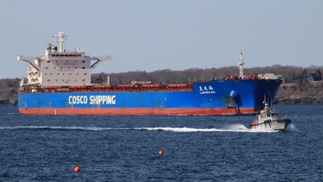 Large blue cargo ship sailing