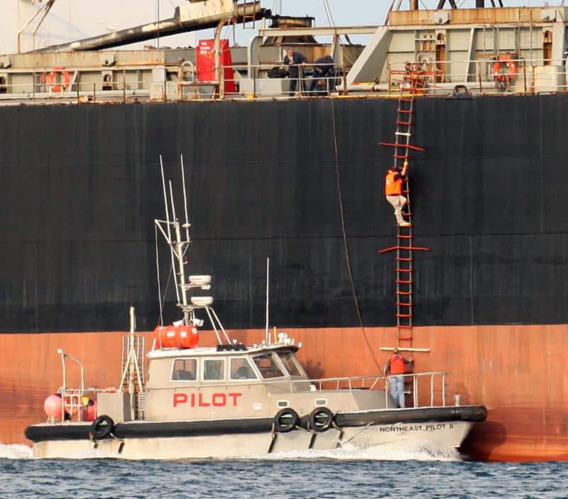 Pilot boat and climbing sailor