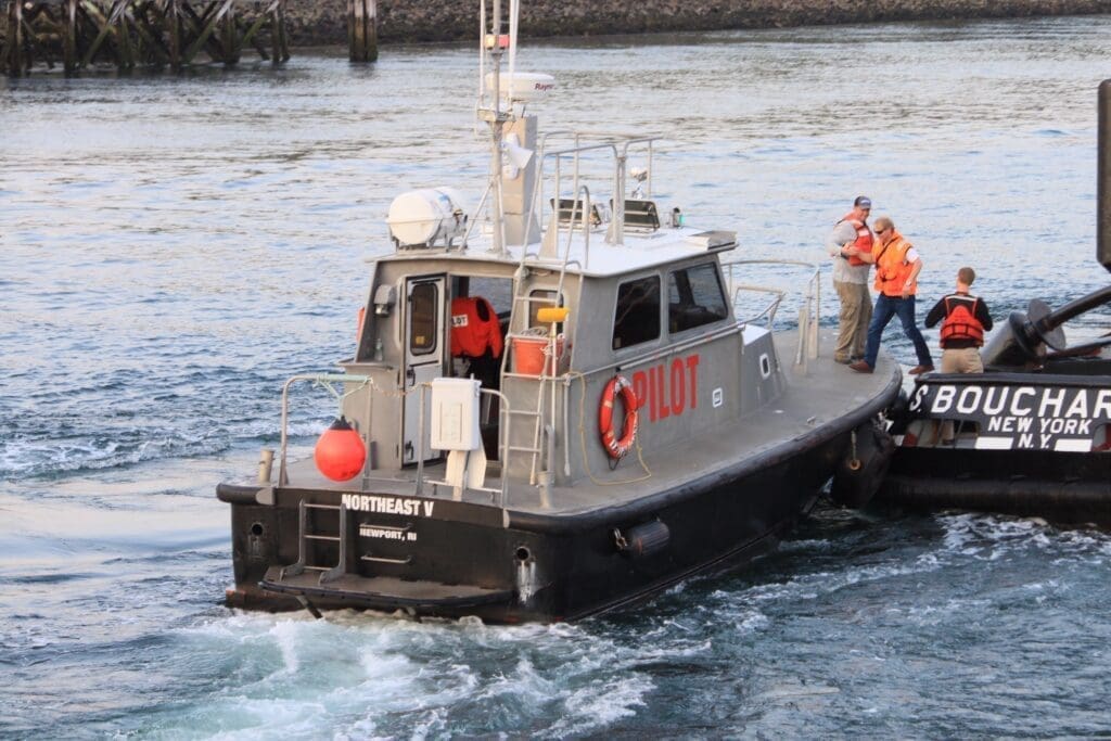 Pilot boat assisting ship